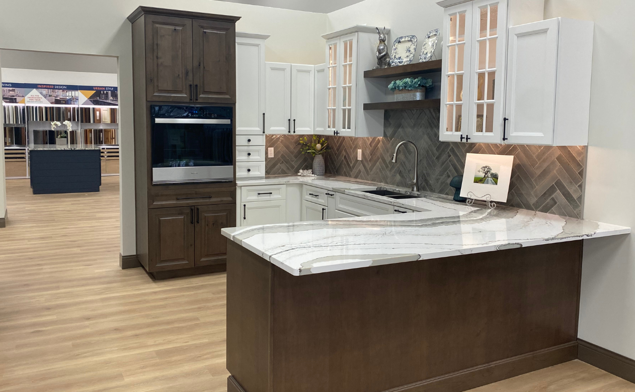 Kitchen with white cabinets and marble countertops and grey backsplash