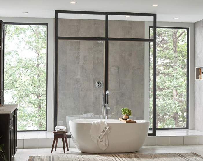 Gray and marble wall tile on a shower wall with freestanding tub
